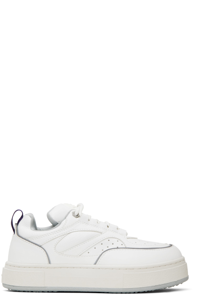 Low-top paneled buffed faux-leather sneakers in white. Reflective trim in gray throughout. 

· Perforated detailing at toe
· Lace-up closure
· Rubberized logo patch at padded tongue
· Padded collar
· Grosgrain pull-loop at heel counter
· Jersey lining
· Logo embossed at textured rubber midsole
· Treaded rubber outsole

Supplier color: Vegan white mist