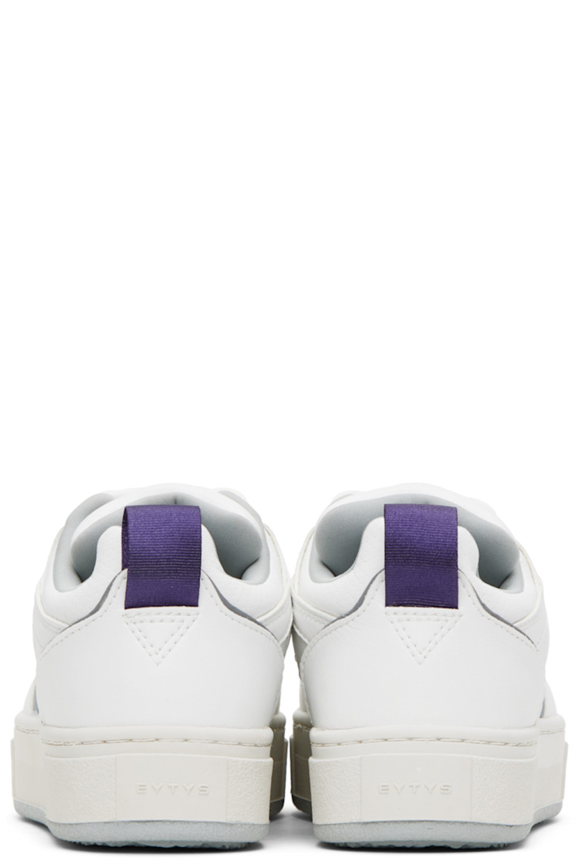 Low-top paneled buffed faux-leather sneakers in white. Reflective trim in gray throughout. 

· Perforated detailing at toe
· Lace-up closure
· Rubberized logo patch at padded tongue
· Padded collar
· Grosgrain pull-loop at heel counter
· Jersey lining
· Logo embossed at textured rubber midsole
· Treaded rubber outsole

Supplier color: Vegan white mist