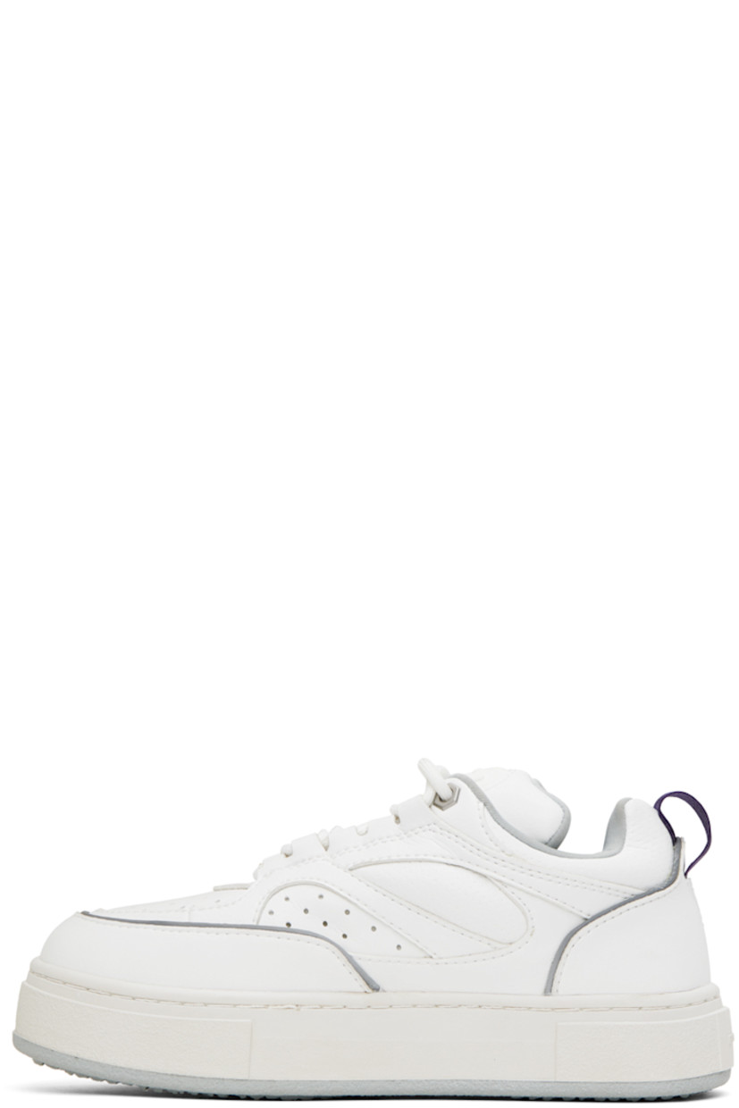 Low-top paneled buffed faux-leather sneakers in white. Reflective trim in gray throughout. 

· Perforated detailing at toe
· Lace-up closure
· Rubberized logo patch at padded tongue
· Padded collar
· Grosgrain pull-loop at heel counter
· Jersey lining
· Logo embossed at textured rubber midsole
· Treaded rubber outsole

Supplier color: Vegan white mist
