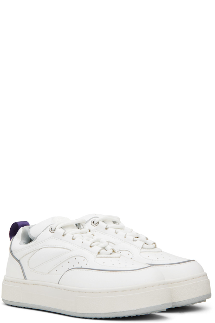 Low-top paneled buffed faux-leather sneakers in white. Reflective trim in gray throughout. 

· Perforated detailing at toe
· Lace-up closure
· Rubberized logo patch at padded tongue
· Padded collar
· Grosgrain pull-loop at heel counter
· Jersey lining
· Logo embossed at textured rubber midsole
· Treaded rubber outsole

Supplier color: Vegan white mist
