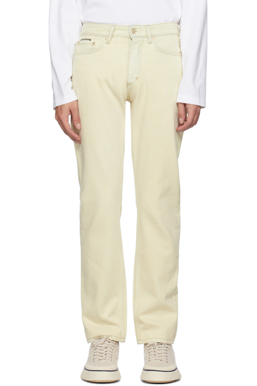 Non-stretch denim jeans. 

· Belt loops 
· Five-pocket styling 
· Button-fly 
· Logo patch at front pocket 
· Rubberized logo patch at back waistband 
· Logo graphic embroidered at back pocket 
· Logo-engraved gold-tone hardware 

Supplier color: Chalk