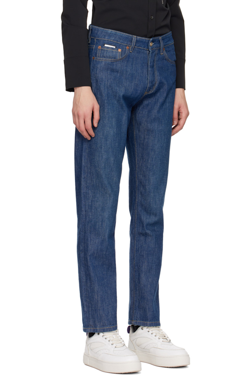 Non-stretch denim jeans.

· Belt loops
· Five-pocket styling
· Button-fly
· Rubberized logo patch at back waistband
· Logo graphic embroidered at back
· Contrast stitching in tan

Supplier color: Crude