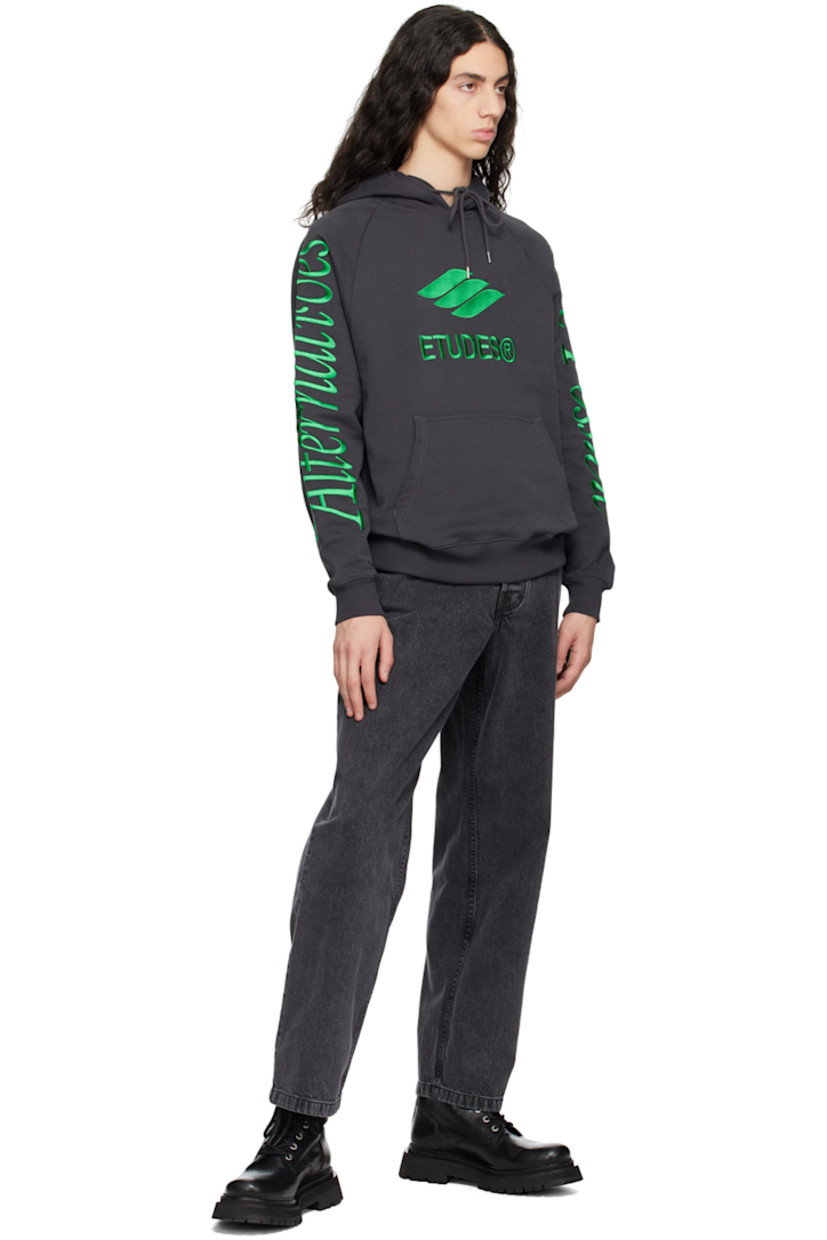 Organic cotton French terry hoodie. 

· Drawstring at hood
· Logo graphic embroidered at front
· Kangaroo pocket
· Rib knit hem and cuffs
· Text embroidered at raglan sleeves

Supplier color: Black