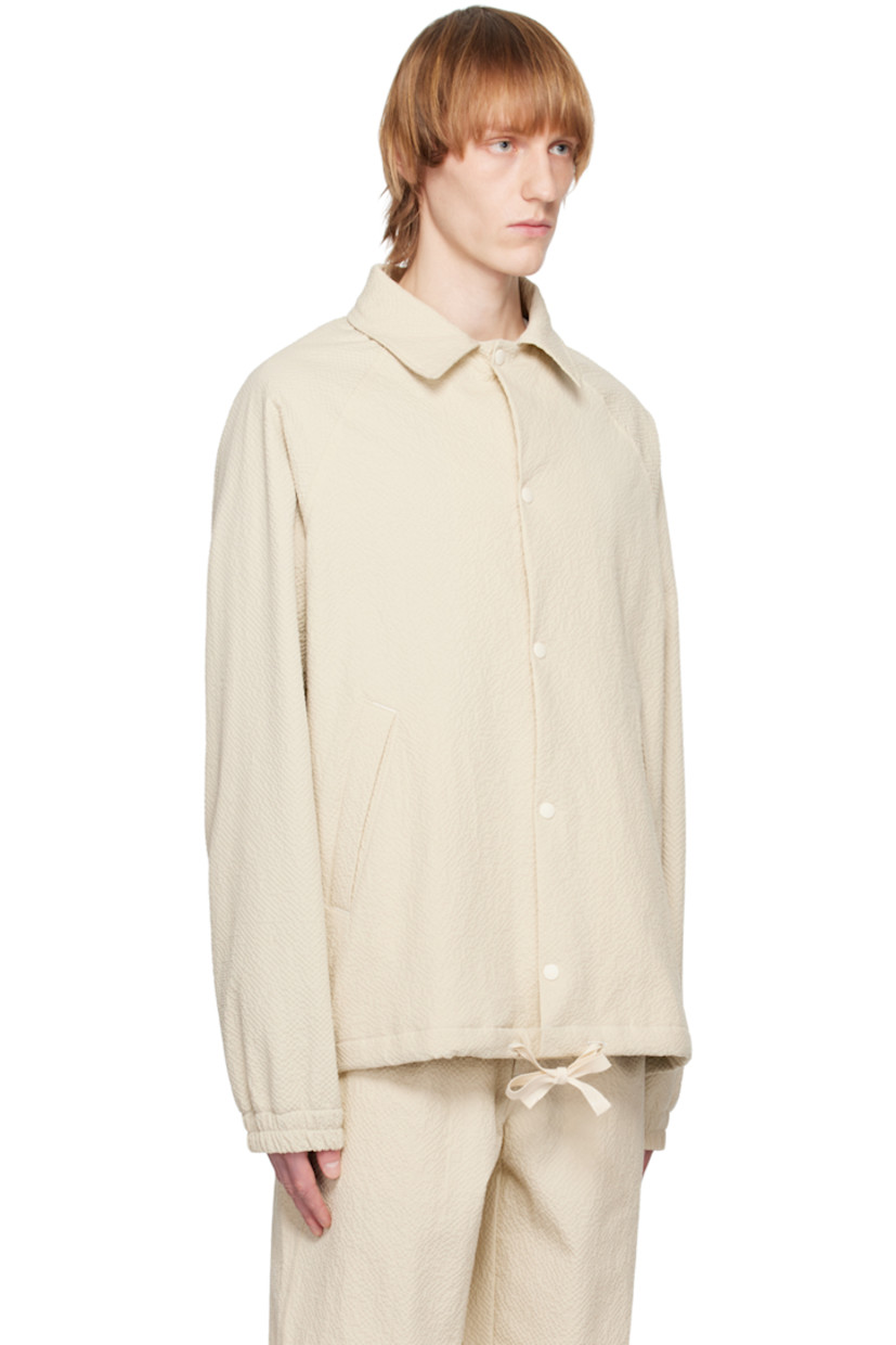 Stretch cotton seersucker jacket.

· Spread collar
· Press-stud closure
· Seam pockets
· Drawstring at hem
· Raglan sleeves
· Elasticized cuffs
· Full mesh lining

Supplier color: Ecru