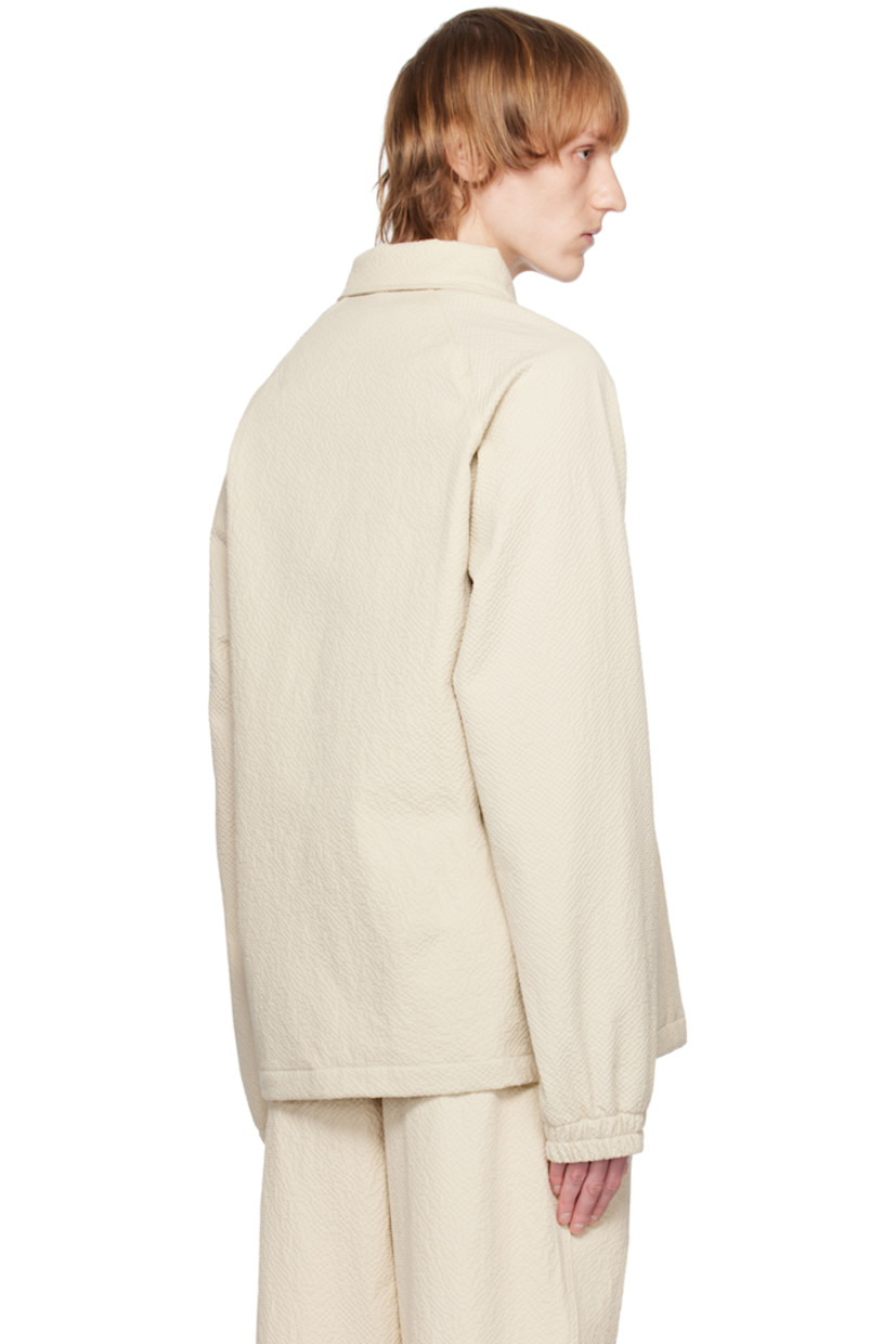 Stretch cotton seersucker jacket.

· Spread collar
· Press-stud closure
· Seam pockets
· Drawstring at hem
· Raglan sleeves
· Elasticized cuffs
· Full mesh lining

Supplier color: Ecru