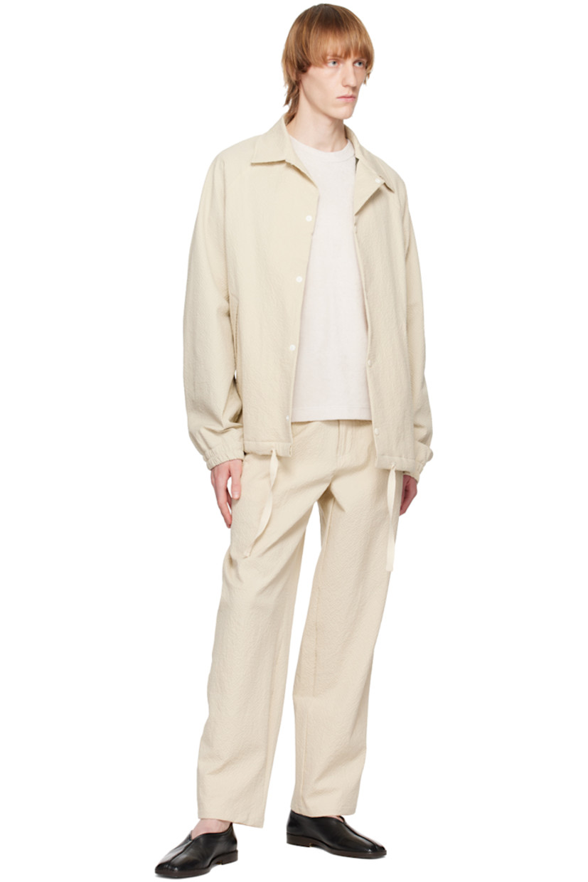 Stretch cotton seersucker jacket.

· Spread collar
· Press-stud closure
· Seam pockets
· Drawstring at hem
· Raglan sleeves
· Elasticized cuffs
· Full mesh lining

Supplier color: Ecru