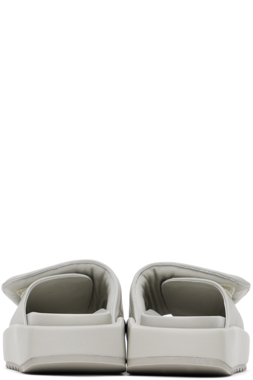 Buffed leather slip-on sandals in gray. 

· Open round toe
· Padded velcro strap at vamp
· Logo embossed at molded footbed
· Covered platform midsole
· Treaded rubber outsole
· Platform: H1.5 in

Supplier color: Stone grey