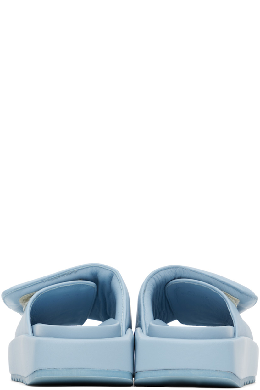 Buffed leather slip-on sandals in blue. 

· Open round toe
· Padded velcro strap at vamp
· Logo embossed at molded footbed
· Covered platform midsole
· Treaded rubber outsole
· Platform: H1.5 in

Supplier color: Ice blue