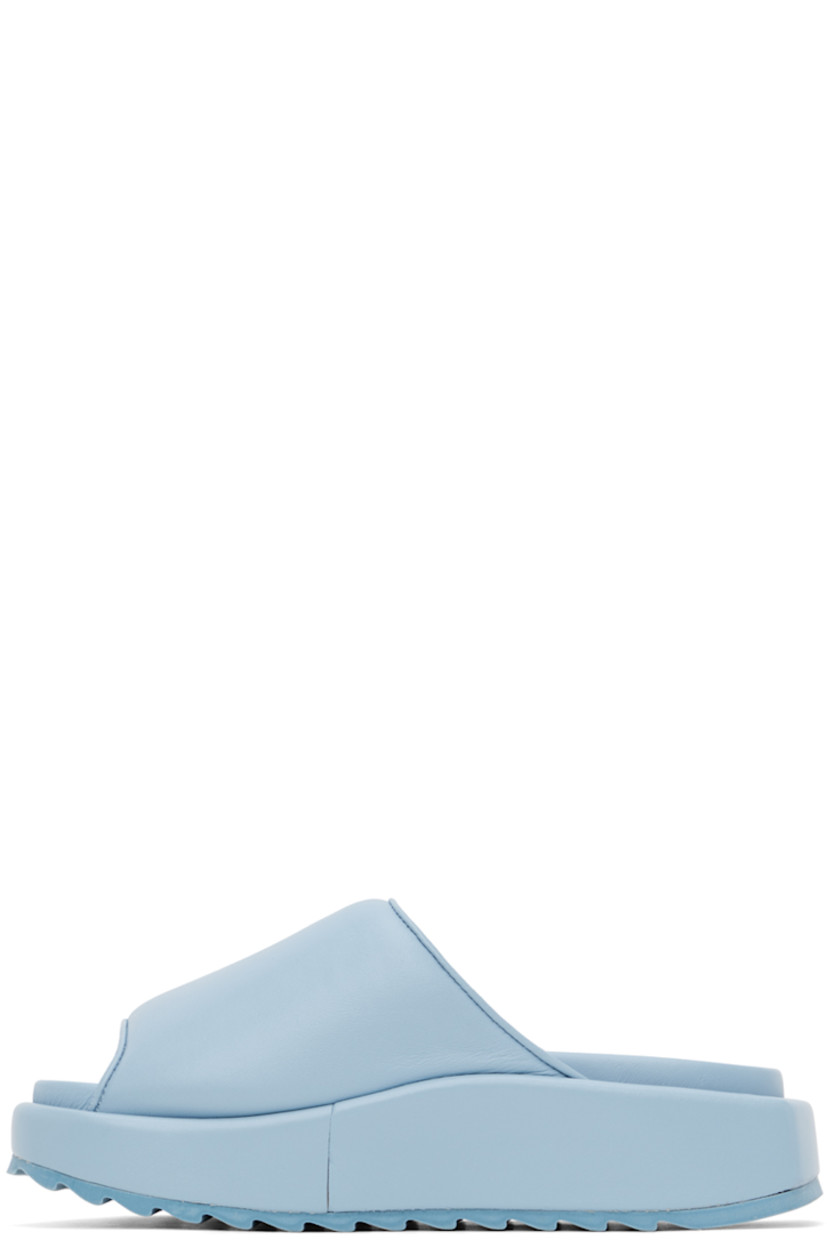 Buffed leather slip-on sandals in blue. 

· Open round toe
· Padded velcro strap at vamp
· Logo embossed at molded footbed
· Covered platform midsole
· Treaded rubber outsole
· Platform: H1.5 in

Supplier color: Ice blue