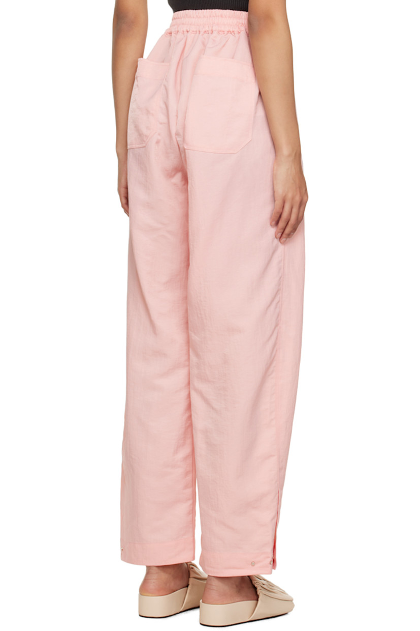 Wide-leg crinkled nylon taffeta trousers. Water-repellent, stain-resistant, and wrinkle-resistant. 

· Partially elasticized waistband
· Four-pocket styling
· Zip-fly
· Press-stud vent at cuffs 

Supplier color: Baby pink