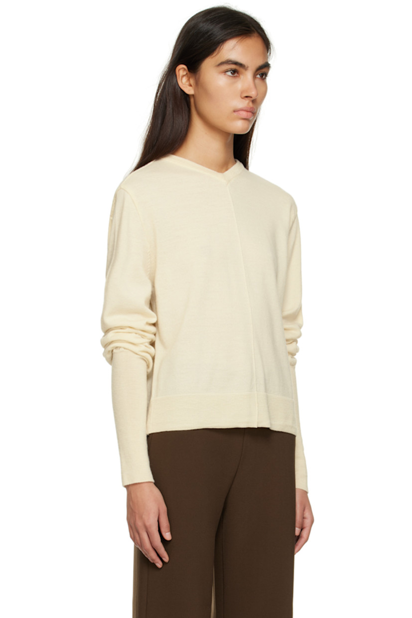 Knit wool sweater. 

· Rib knit V-neck, hem, and cuffs
· Pinched seams at front
· Cutout at back 

Supplier color: Ivory