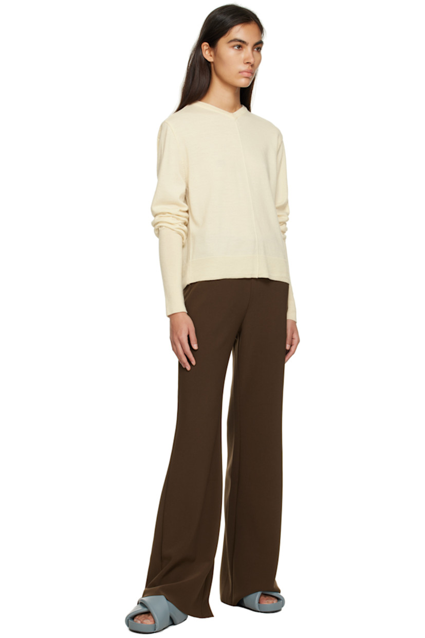 Knit wool sweater. 

· Rib knit V-neck, hem, and cuffs
· Pinched seams at front
· Cutout at back 

Supplier color: Ivory