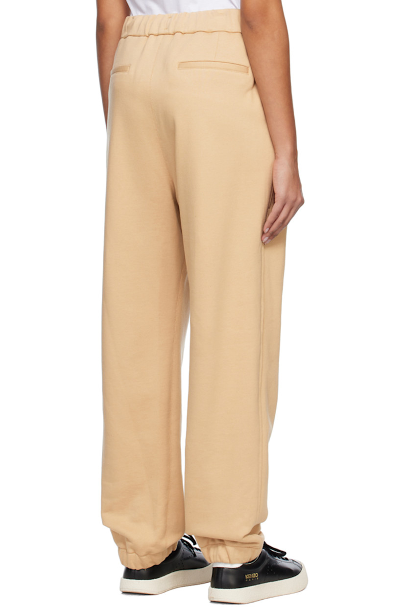 French terry lounge pants.

· Drawstring at elasticized waistband
· Four-pocket styling
· Logo embroidered at front leg
· Concealed bungee-style drawstring at elasticized cuffs
· Logo-engraved silver-tone hardware

Supplier color: Beige
