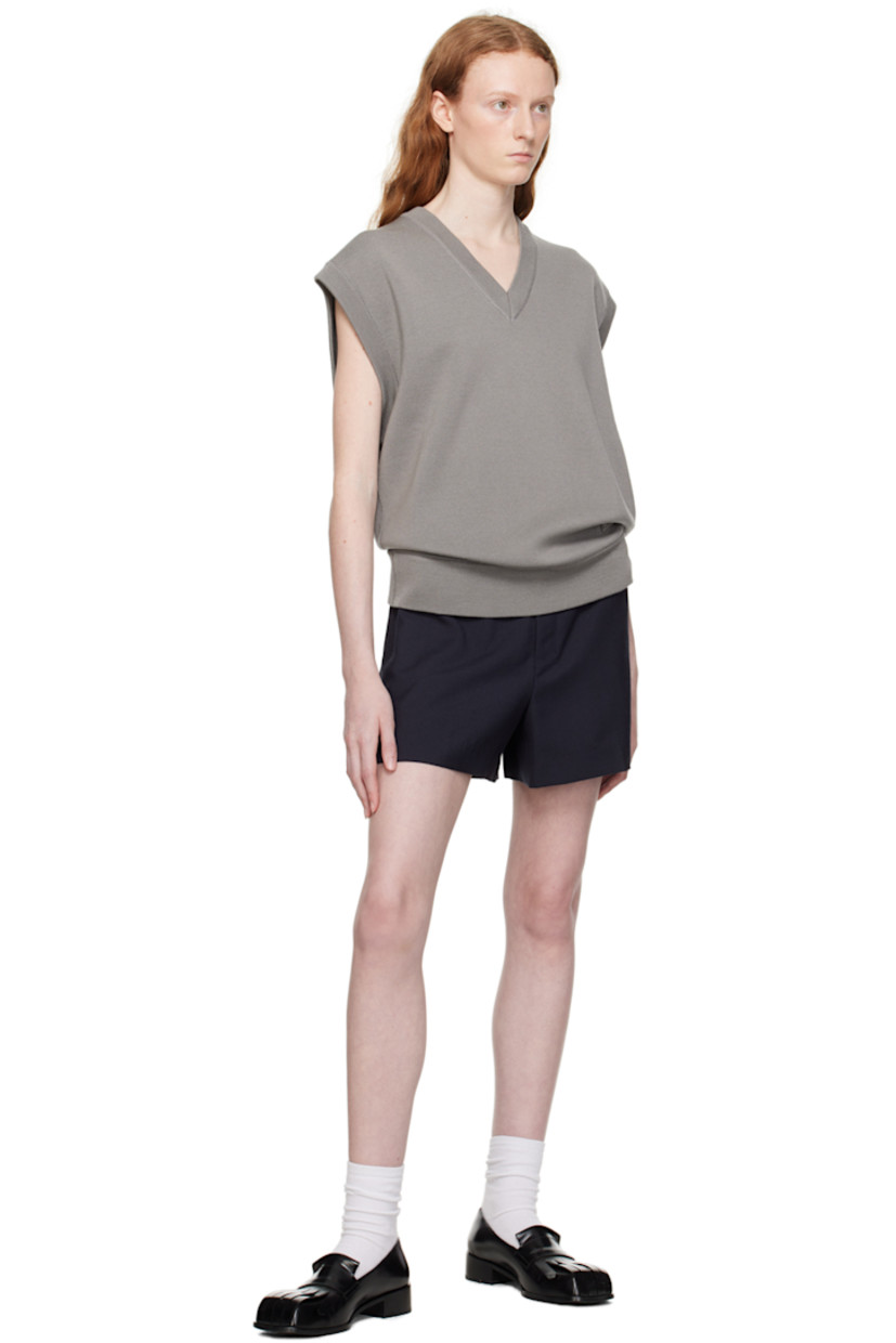 Knit wool vest.

· Rib knit V-neck, hem, and armscyes 
· Embroidered logo patch at hem 
· Leather logo patch at back collar 

Supplier color: Gray