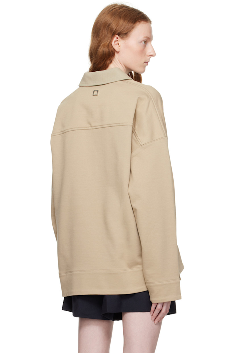 French terry polo. 

· Cotton canvas spread collar
· Two-press-stud placket
· Logo embroidered at chest 
· Vented side seams
· Logo hardware at back collar 

Supplier color: Beige