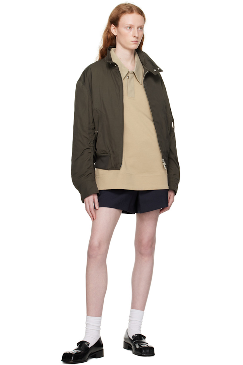 French terry polo. 

· Cotton canvas spread collar
· Two-press-stud placket
· Logo embroidered at chest 
· Vented side seams
· Logo hardware at back collar 

Supplier color: Beige