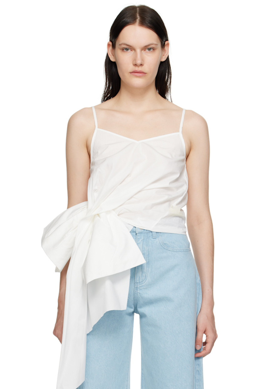 Organic cotton poplin camisole.

· Layered construction
· V-neck
· Raw edge at asymmetrical hem
· Adjustable spaghetti shoulder straps with cinch fastening

Supplier color: White