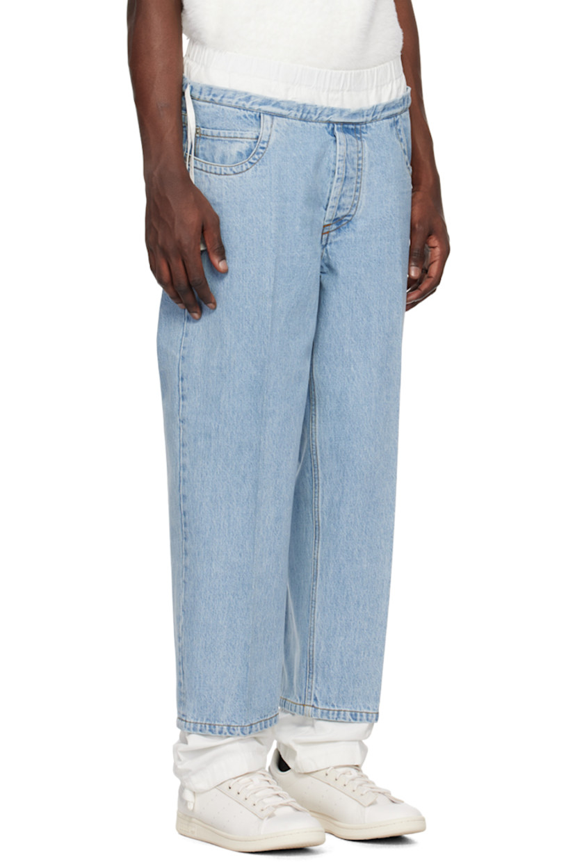 Non-stretch denim and cotton twill jeans. Fading throughout. 

· Layered construction
· Elasticized waistband
· Drawstrings at waistband and cuffs
· Five-pocket styling
· Button-fly
· Central creases at front and back
· Eyelet vent at back pocket
· Contrast stitching in tan

Supplier color: Light blue