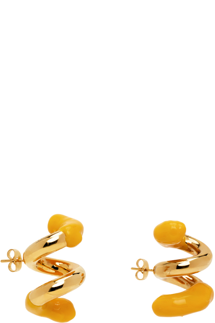 Pair of drop earrings in gold-tone brass. Twisted detailing throughout.

· Hand-rubberized accent in yellow at length
· Logo etched at side
· Post-stud fastening 
· H1.5" x W1"

Supplier color: Gold/Apricot