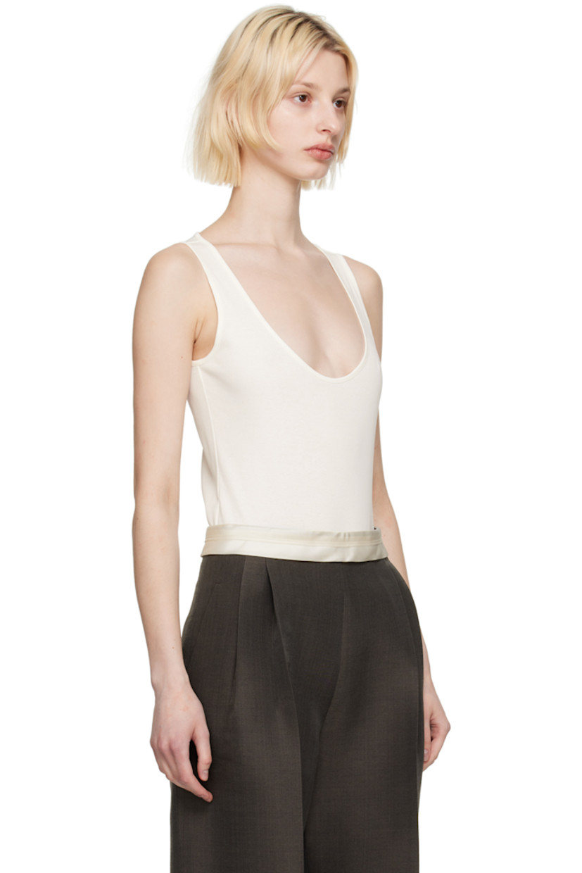 Rib knit cotton bodysuit.

· Scoop neck
· Press-stud closure at bottom

Supplier color: Cream