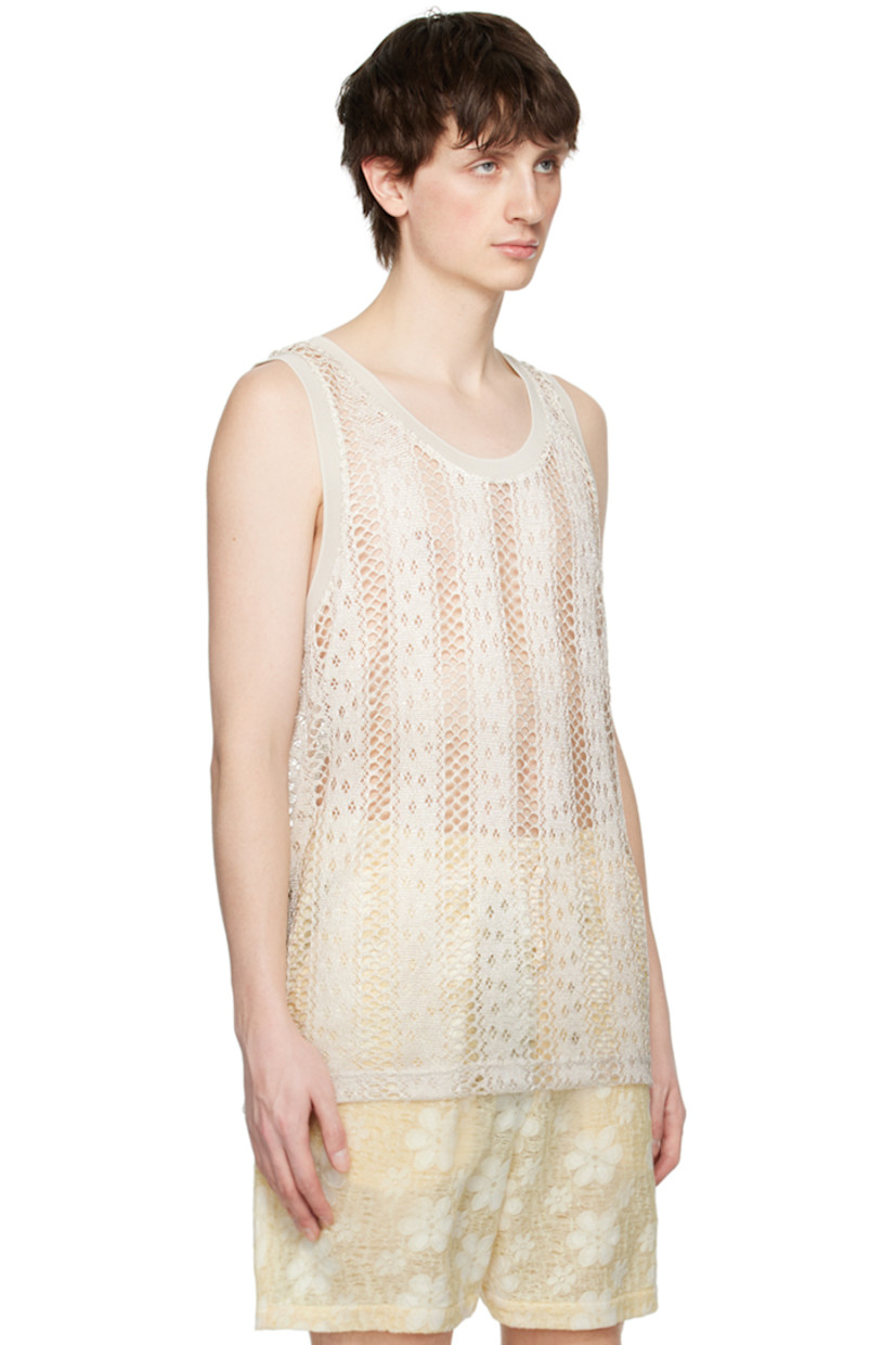 Open knit and pointelle knit polyester tank top. Rib knit scoop neck and armscyes.

Supplier color: White