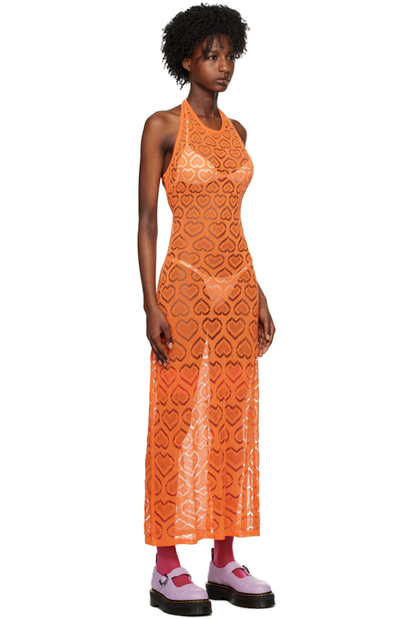 Semi-sheer raschel knit viscose-blend dress. Graphic pattern throughout.

· Rib knit scoop neck and hem
· Vented side seam
· Self-tie halter strap
· Self-tie fastenings at open back

Available exclusively at SSENSE. 

Supplier color: Orange