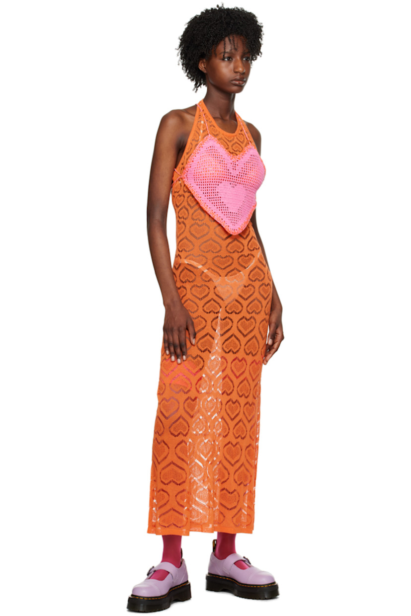Semi-sheer raschel knit viscose-blend dress. Graphic pattern throughout.

· Rib knit scoop neck and hem
· Vented side seam
· Self-tie halter strap
· Self-tie fastenings at open back

Available exclusively at SSENSE. 

Supplier color: Orange