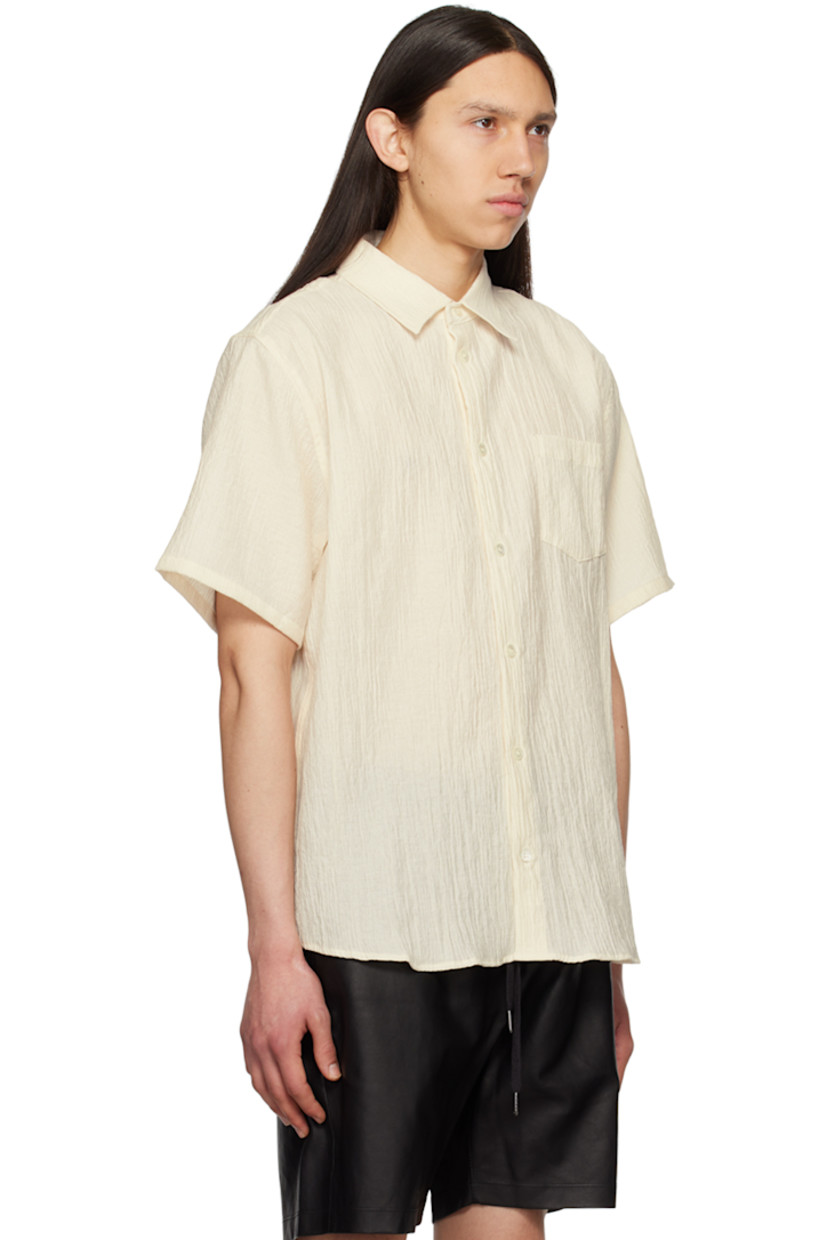 Cotton- and nylon-blend seersucker shirt.

· Spread collar
· Button closure
· Patch pocket at chest
· Shirttail hem
· Inverted box pleat at back yoke

Supplier color: Salt