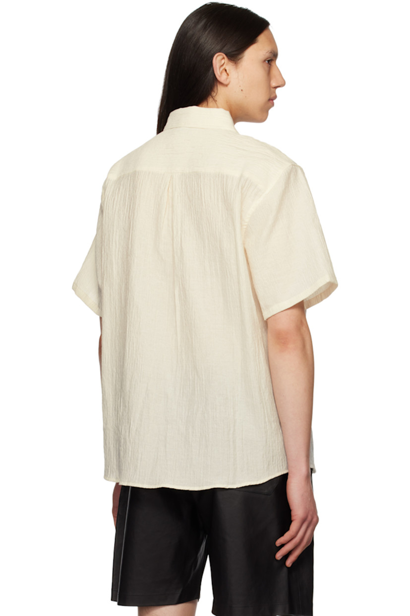 Cotton- and nylon-blend seersucker shirt.

· Spread collar
· Button closure
· Patch pocket at chest
· Shirttail hem
· Inverted box pleat at back yoke

Supplier color: Salt