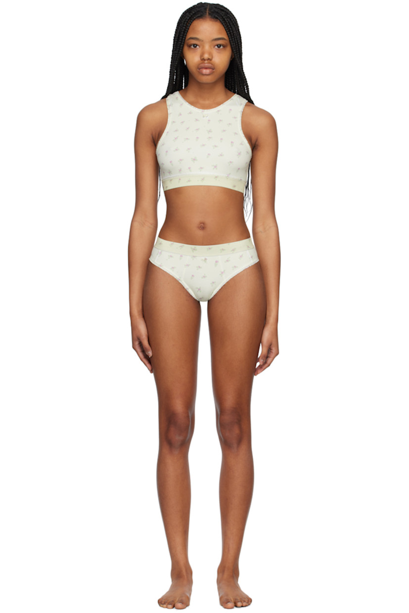 Stretch nylon jersey bikini top. Ruffled trim and floral pattern printed throughout.

· Bow accent at round neck
· Elasticized hem
· Cutout at back
· Fully lined

Stretch nylon jersey bikini bottoms. Ruffled trim and floral pattern printed throughout.

· Elasticized waistband
· Bow accent at front
· Fully lined

Supplier color: Printed flowers light