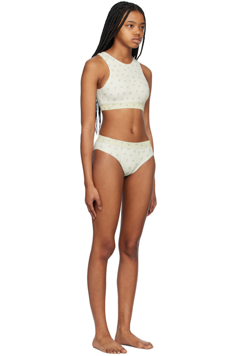 Stretch nylon jersey bikini top. Ruffled trim and floral pattern printed throughout.

· Bow accent at round neck
· Elasticized hem
· Cutout at back
· Fully lined

Stretch nylon jersey bikini bottoms. Ruffled trim and floral pattern printed throughout.

· Elasticized waistband
· Bow accent at front
· Fully lined

Supplier color: Printed flowers light