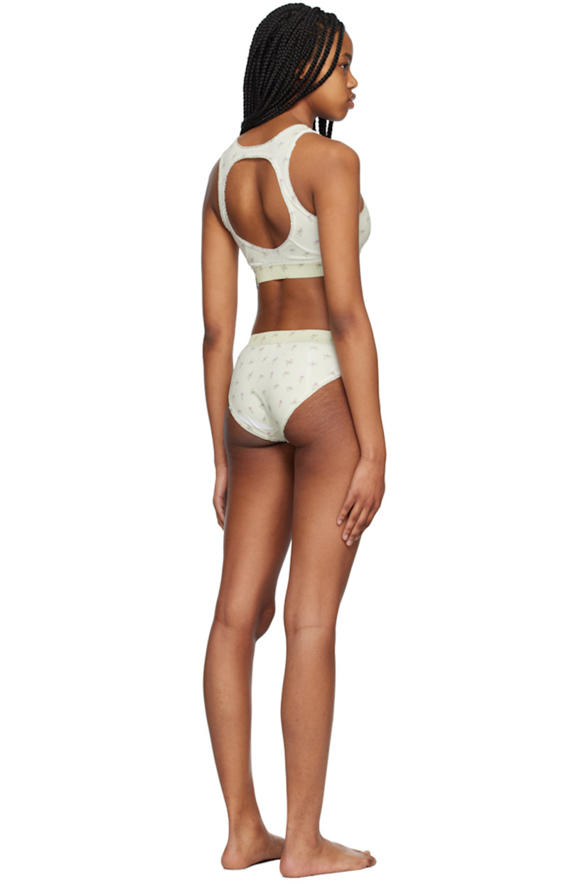 Stretch nylon jersey bikini top. Ruffled trim and floral pattern printed throughout.

· Bow accent at round neck
· Elasticized hem
· Cutout at back
· Fully lined

Stretch nylon jersey bikini bottoms. Ruffled trim and floral pattern printed throughout.

· Elasticized waistband
· Bow accent at front
· Fully lined

Supplier color: Printed flowers light