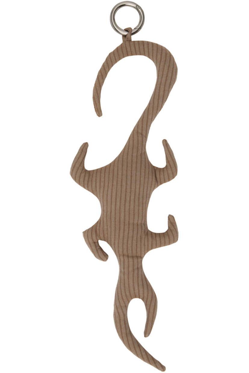 Padded graphic cotton twill keychain in tan. Stripes throughout. 

· Hinged O-ring fastening 
· H16 x W2.5 in 

Supplier color: Tan