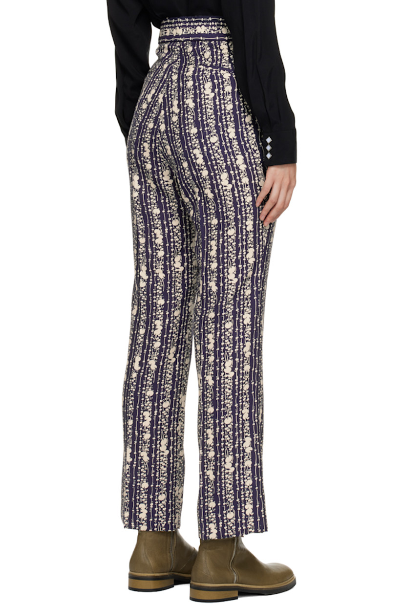 Polyester hopsack trousers. Graphic pattern printed throughout.

· Four-pocket styling
· Zip-fly
· Central creases at front and back
· Adjustable elasticized button tabs at back
· Darts at back

Supplier color: Dark navy