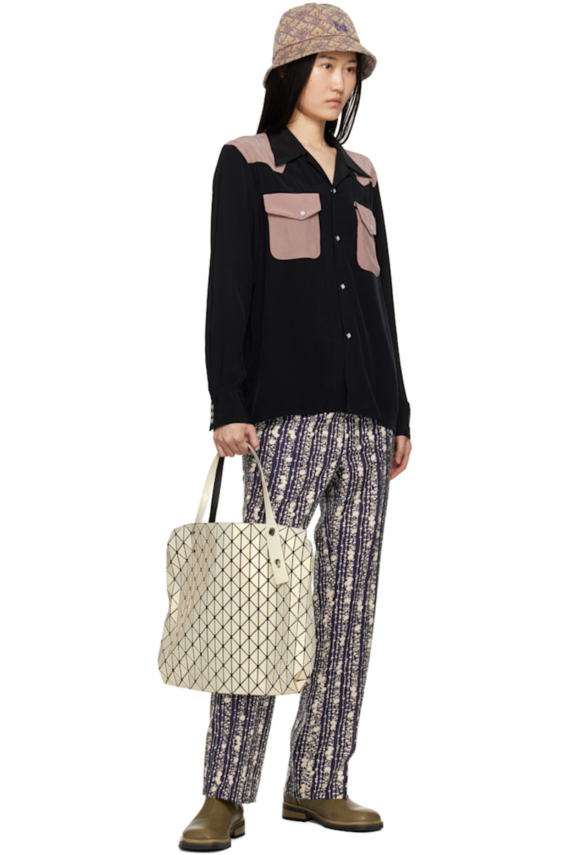 Polyester hopsack trousers. Graphic pattern printed throughout.

· Four-pocket styling
· Zip-fly
· Central creases at front and back
· Adjustable elasticized button tabs at back
· Darts at back

Supplier color: Dark navy