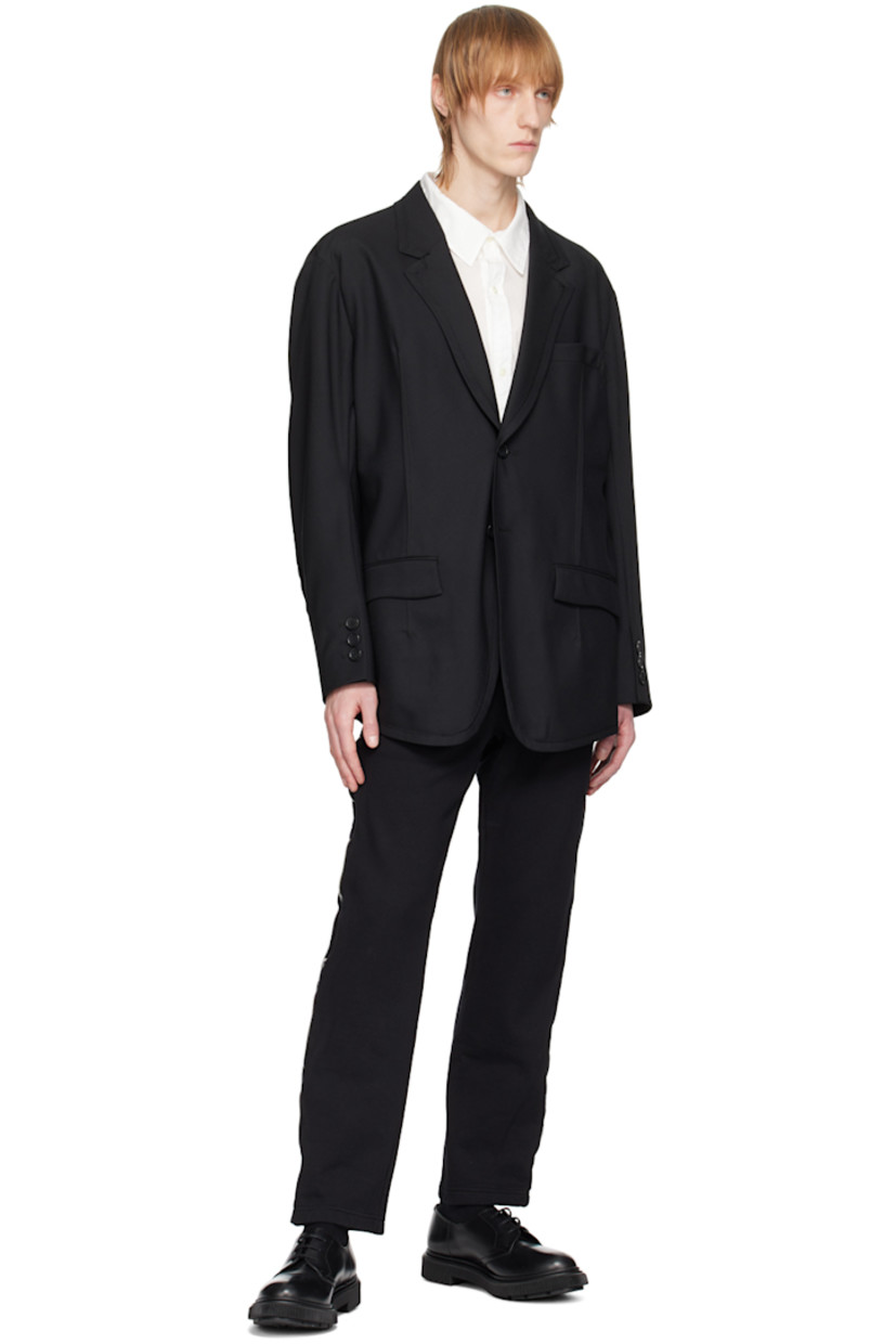 Wool-blend twill blazer. 

· Notched lapel
· Two-button closure
· Flap pockets
· Exposed darts at front
· Padded shoulders
· Three-button surgeon's cuffs 
· Partial cupro satin lining

Supplier color: Black