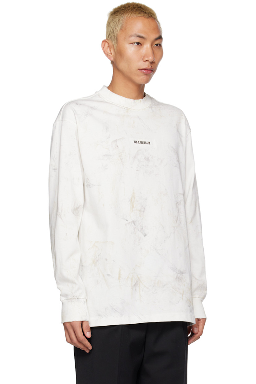Knit cotton T-shirt. Distressing and pattern printed throughout. 

· Rib knit crewneck and cuffs
· Logo hardware at front 
· Dropped shoulders 

Supplier color: Dirty off-white