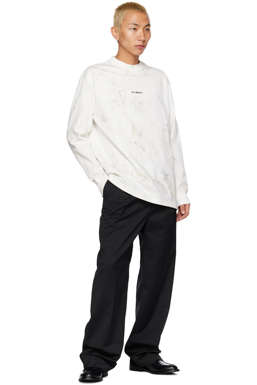 Knit cotton T-shirt. Distressing and pattern printed throughout. 

· Rib knit crewneck and cuffs
· Logo hardware at front 
· Dropped shoulders 

Supplier color: Dirty off-white