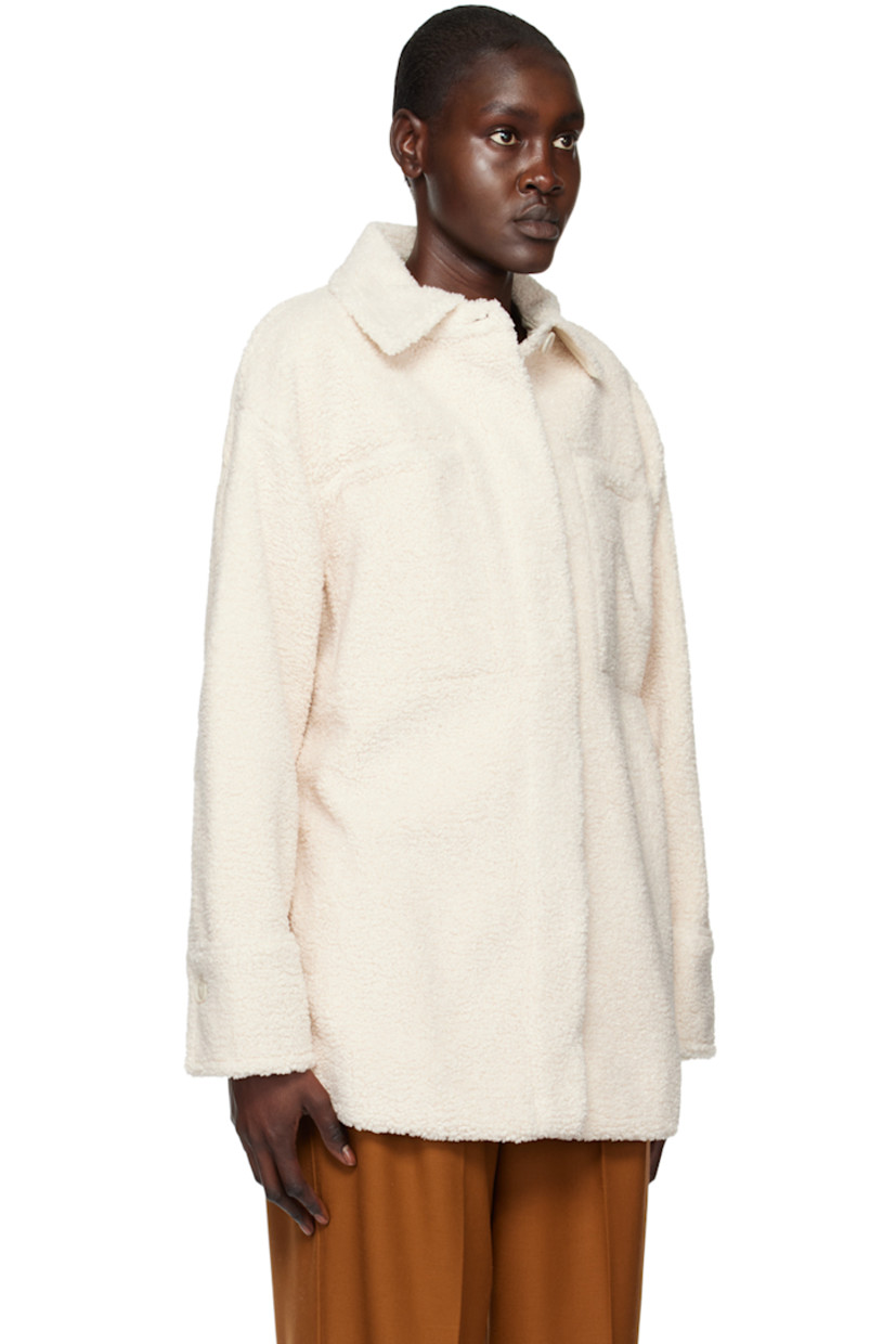 Polyester sherpa fleece jacket. 

· Spread collar 
· Concealed button closure 
· Welt pockets and seam pockets 
· Curved hem
· Single-button barrel cuffs 
· Full faux-suede lining 

Supplier color: Chiffon