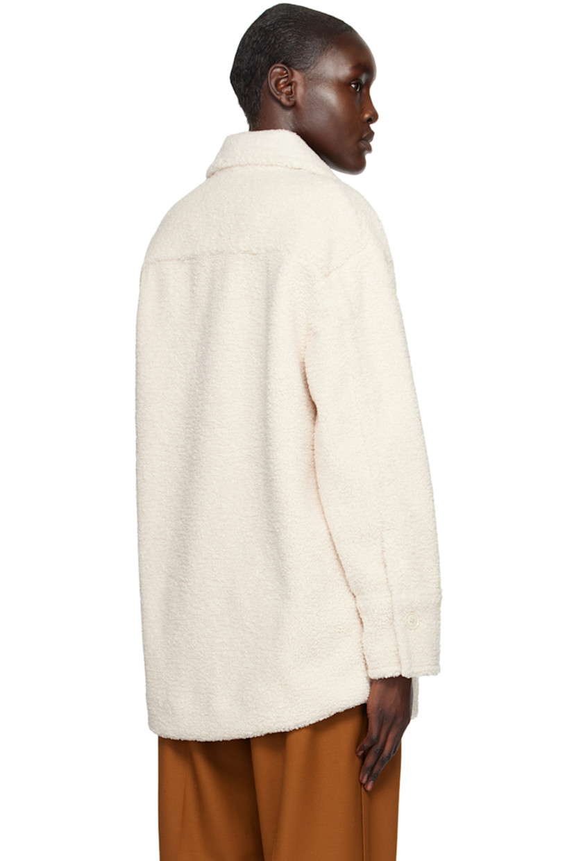Polyester sherpa fleece jacket. 

· Spread collar 
· Concealed button closure 
· Welt pockets and seam pockets 
· Curved hem
· Single-button barrel cuffs 
· Full faux-suede lining 

Supplier color: Chiffon