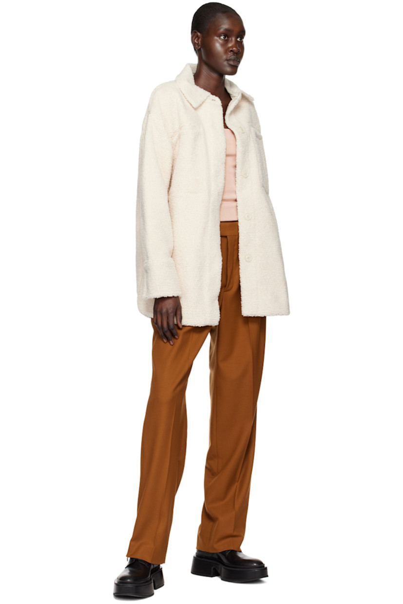 Polyester sherpa fleece jacket. 

· Spread collar 
· Concealed button closure 
· Welt pockets and seam pockets 
· Curved hem
· Single-button barrel cuffs 
· Full faux-suede lining 

Supplier color: Chiffon