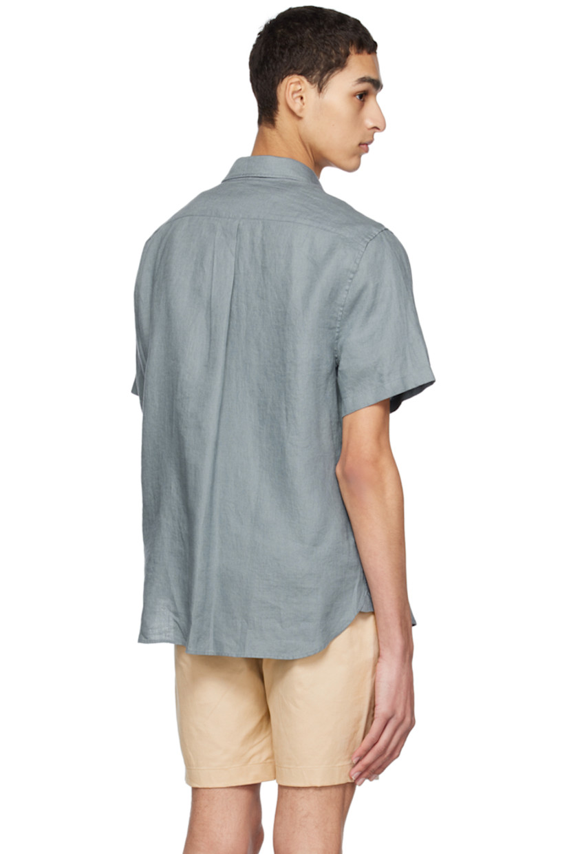 Plain-woven linen shirt. 

· Spread collar
· Button closure
· Patch pocket
· Shirttail hem
· Box pleat at back yoke

Supplier color: Teal pool