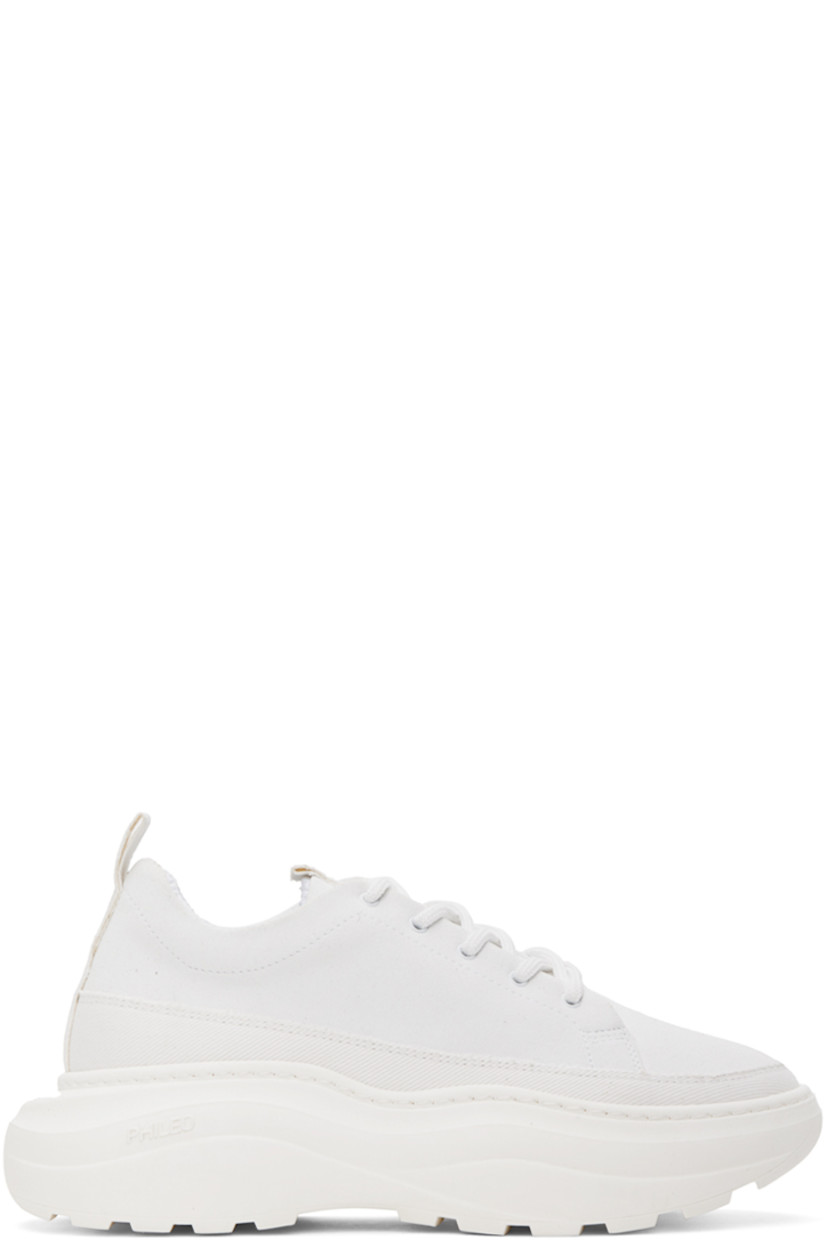 Low-top paneled faux-suede and twill sneakers in white. 

· Lace-up closure 
· Pull-loop at padded tongue and heel
· Padded collar 
· Mesh lining
· Logo embossed at rubber platform midsole
· Treaded rubber outsole
· Platform: H2.25 in

Supplier color: White
