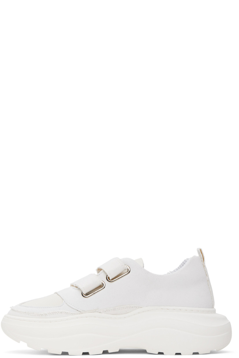 Low-top paneled faux-suede, canvas, and twill sneakers in white. 

· Velcro closure
· Padded tongue and collar
· Pull-loop at heel collar
· Mesh lining
· Logo embossed at rubber platform midsole
· Treaded rubber outsole
· Platform: H2.25 in

Supplier color: White