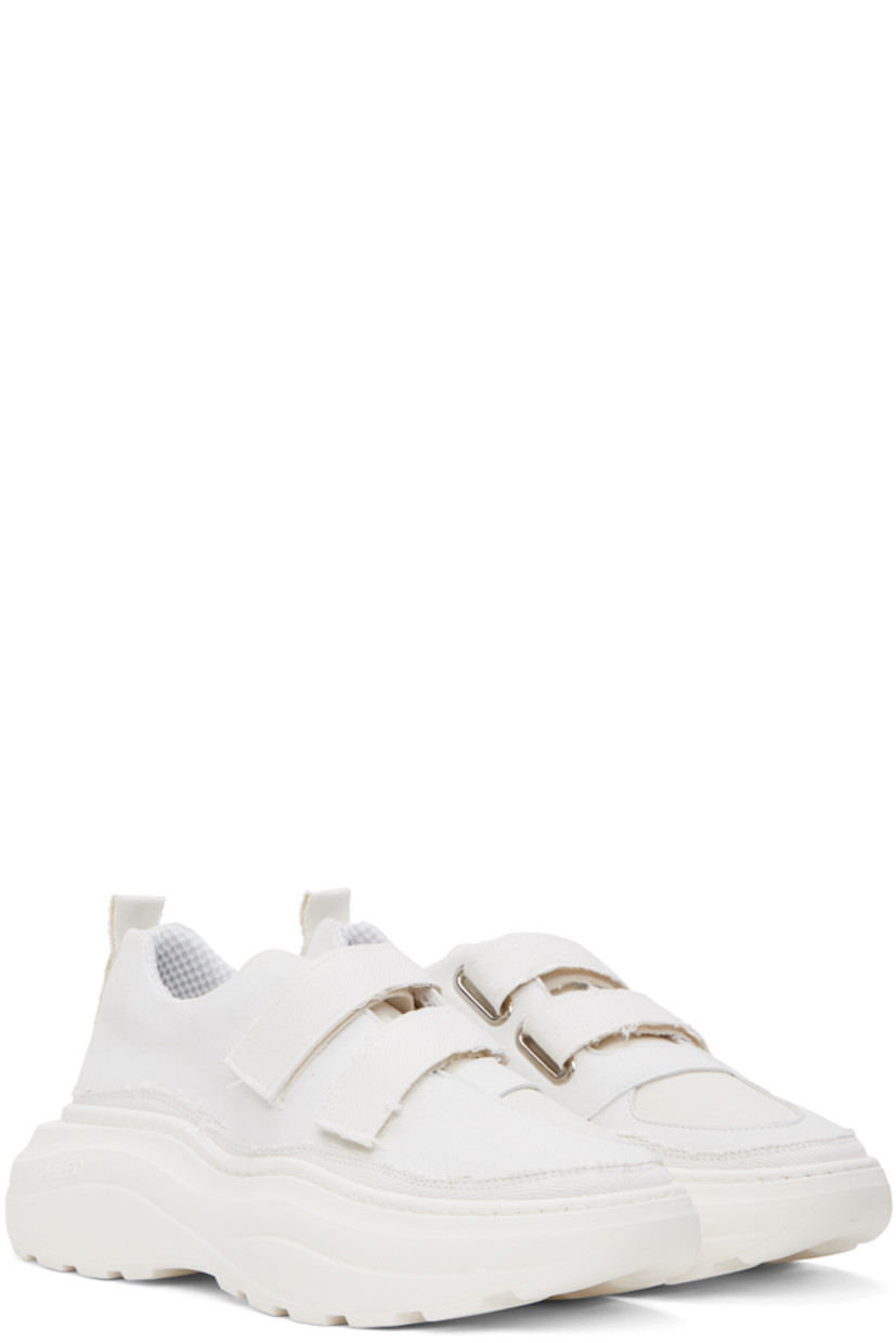 Low-top paneled faux-suede, canvas, and twill sneakers in white. 

· Velcro closure
· Padded tongue and collar
· Pull-loop at heel collar
· Mesh lining
· Logo embossed at rubber platform midsole
· Treaded rubber outsole
· Platform: H2.25 in

Supplier color: White