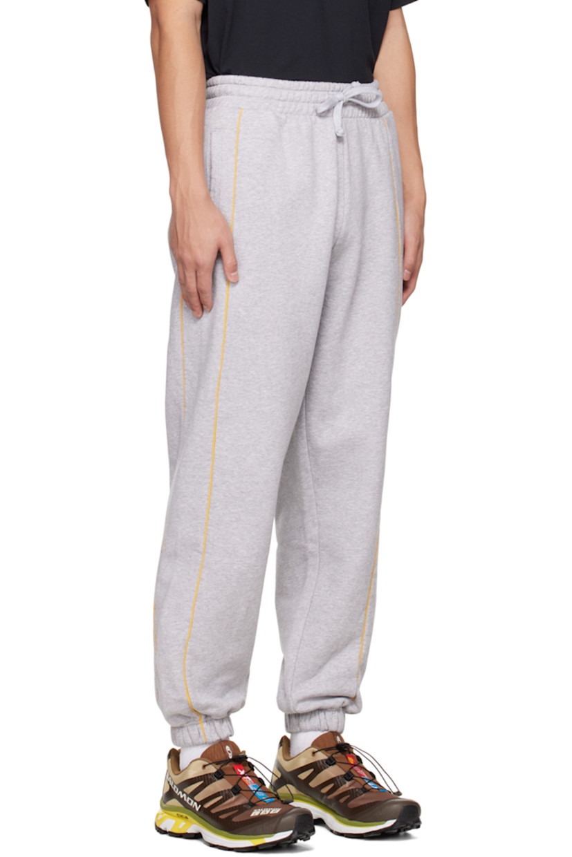 Paneled organic cotton fleece lounge pants.

· Adjustable drawstring at elasticized waistband
· Two-pocket styling
· Piping trim at front and back
· Logo graphic printed at leg
· Elasticized cuffs

Supplier color: Heather grey