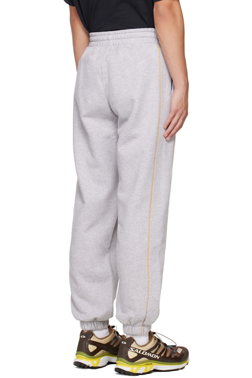 Paneled organic cotton fleece lounge pants.

· Adjustable drawstring at elasticized waistband
· Two-pocket styling
· Piping trim at front and back
· Logo graphic printed at leg
· Elasticized cuffs

Supplier color: Heather grey