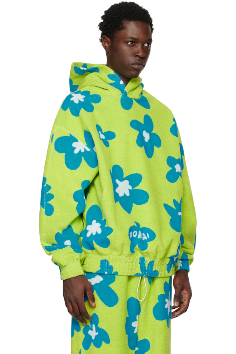 Reverse French terry hoodie. Jacquard graphic throughout. 

· Seam pockets  
· Elasticized hem and cuffs 

Supplier color: Acid green/Azure