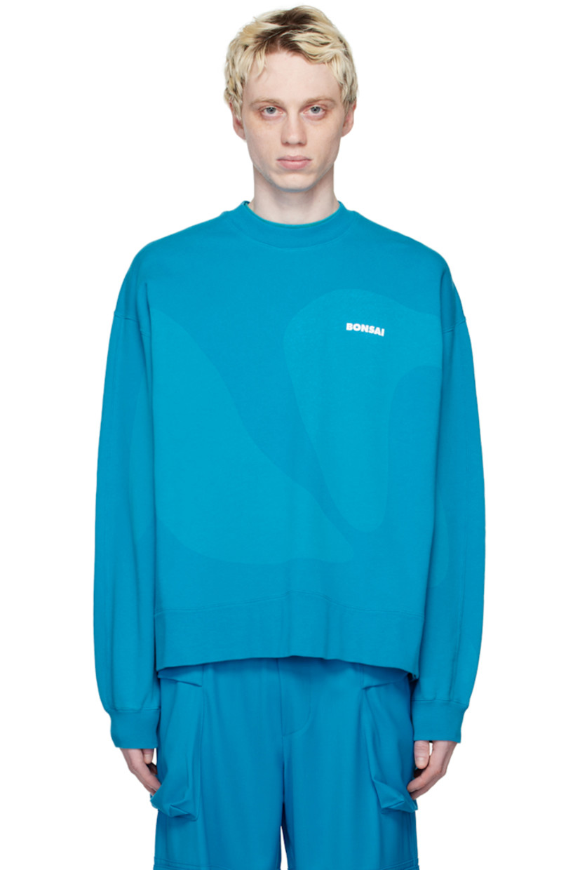 French terry sweatshirt. Graphic printed throughout.

· Rib knit crewneck, hem, and cuffs
· Logo printed at chest
· Dropped shoulders

Supplier color: Azure