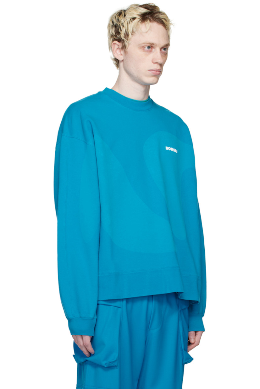 French terry sweatshirt. Graphic printed throughout.

· Rib knit crewneck, hem, and cuffs
· Logo printed at chest
· Dropped shoulders

Supplier color: Azure